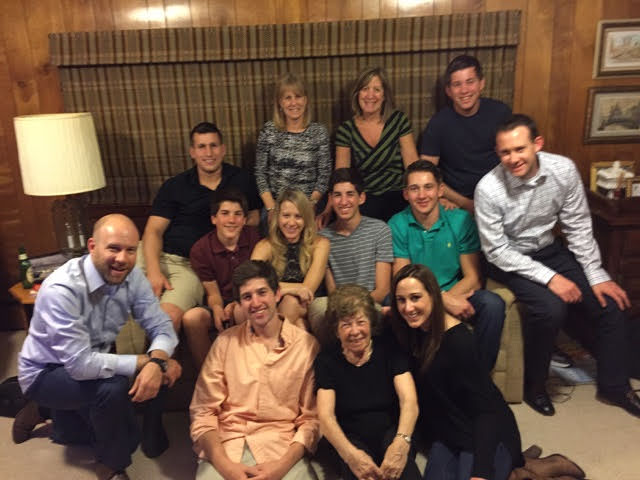 Clara surrounded by family on the couch