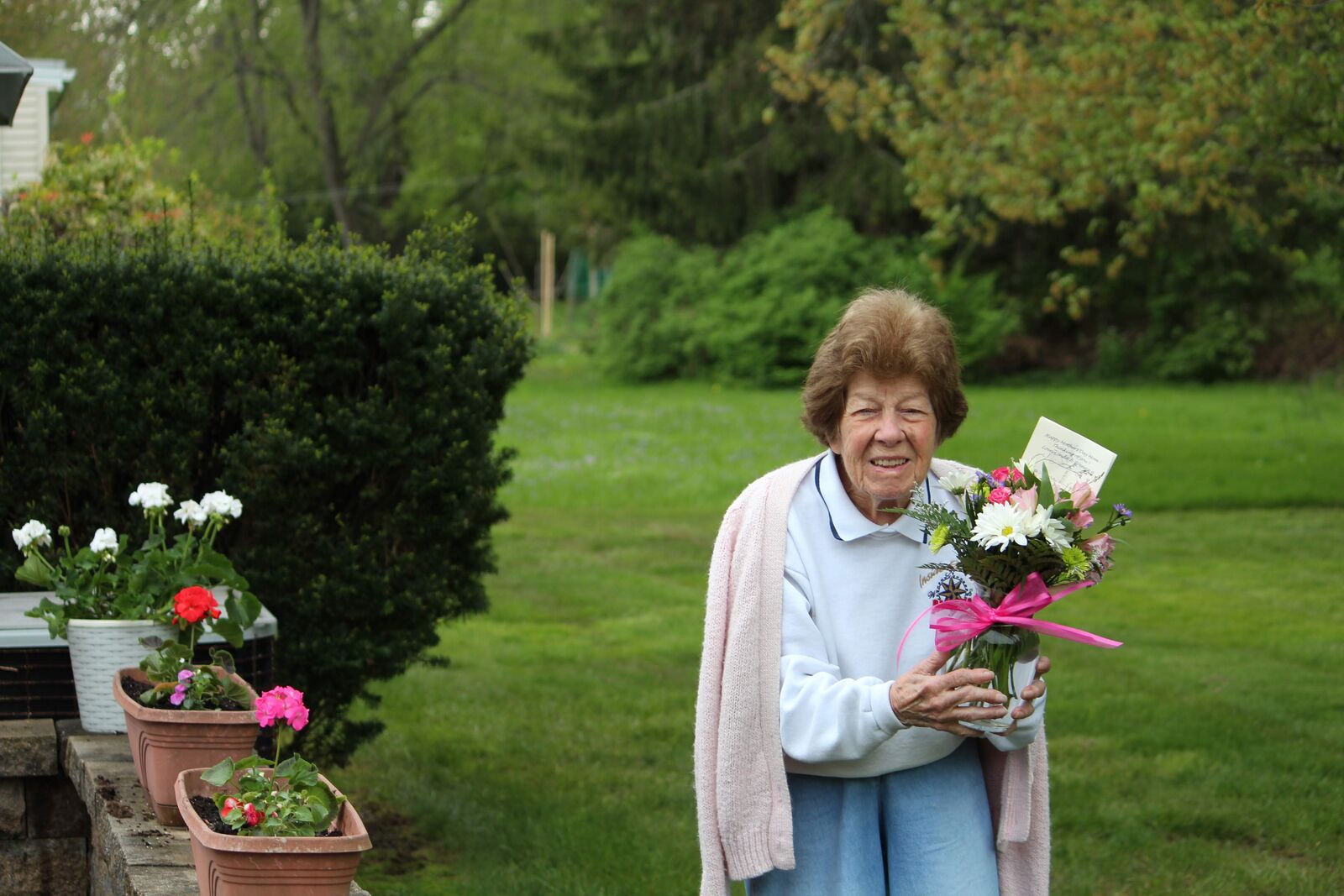 Clara holding flowers in the garden
