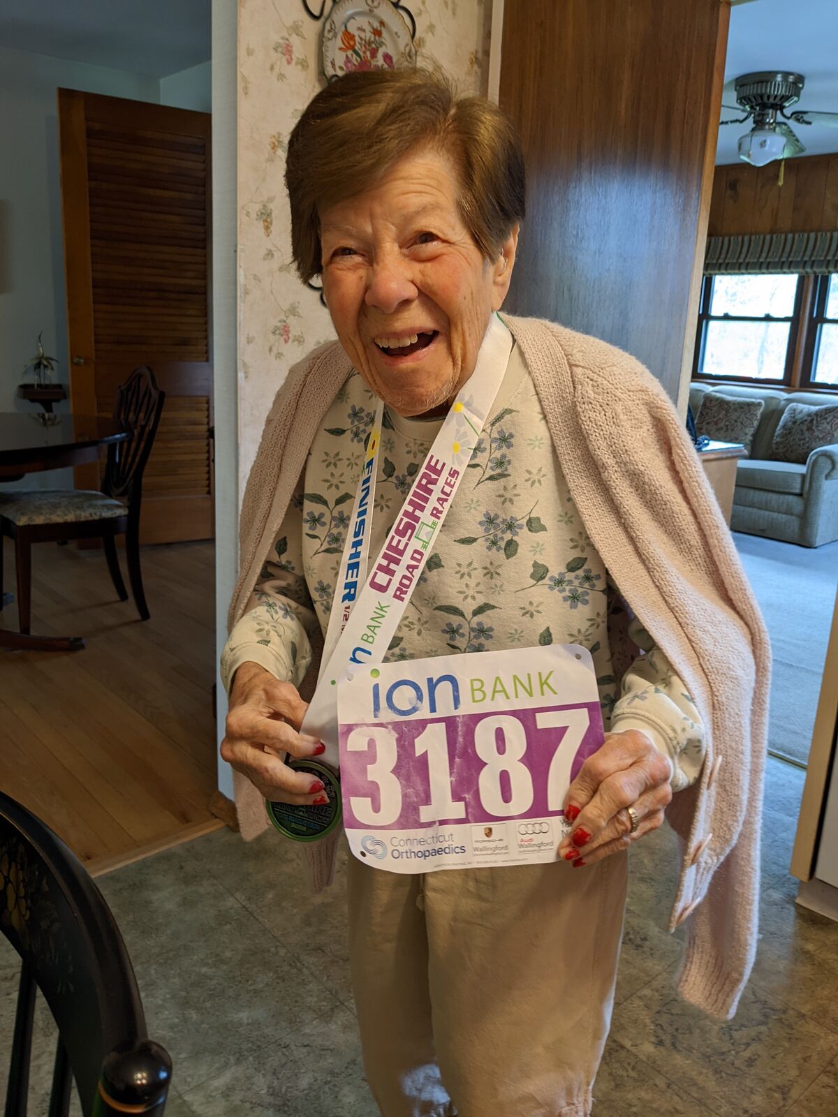 Clara with race bib and medal